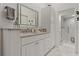 Clean bathroom with granite counters, white cabinets, vanity lighting and an all-glass standing shower at 2026 Golfview Dr # 2026, Tarpon Springs, FL 34689