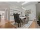 Dining room featuring stylish chairs, modern art, elegant light fixture, and a bright open view to the kitchen at 2026 Golfview Dr # 2026, Tarpon Springs, FL 34689