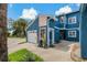 Charming two-story home with a blue exterior, front lawn, and attached one-car garage at 2026 Golfview Dr # 2026, Tarpon Springs, FL 34689