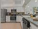 Modern kitchen with stainless steel appliances, granite countertops, and ample cabinet space at 2026 Golfview Dr # 2026, Tarpon Springs, FL 34689