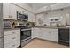 Modern kitchen with stainless steel appliances, granite countertops, and ample cabinet space at 2026 Golfview Dr # 2026, Tarpon Springs, FL 34689