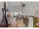 Cozy living room features neutral decor, plush seating, modern fan and opens to a bright outdoor view at 2026 Golfview Dr # 2026, Tarpon Springs, FL 34689