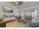 Bright living room with a large sofa, modern decor, and a view of the outdoor scenery through sheer curtains at 2026 Golfview Dr # 2026, Tarpon Springs, FL 34689