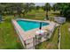 Aerial view of pool with clear blue water and tables and chairs at 2026 Golfview Dr # 2026, Tarpon Springs, FL 34689