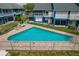 Community pool with blue townhomes in the background at 2026 Golfview Dr # 2026, Tarpon Springs, FL 34689