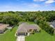 Ariel view of home showing fenced yard, mature landscaping, and detached workshop at 2122 Meadow Lark Rd, Spring Hill, FL 34608