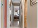Hallway view of a bedroom with natural light and neutral tones at 2122 Meadow Lark Rd, Spring Hill, FL 34608