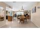 Open living room features a ceiling fan, tile floors, and dining area at 2122 Meadow Lark Rd, Spring Hill, FL 34608