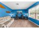 Comfortable living room showcasing decor, wood floors, and large windows at 2122 Meadow Lark Rd, Spring Hill, FL 34608