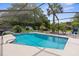 Sparkling pool with sun-drenched seating area and landscaped backyard perfect for entertaining at 2122 Meadow Lark Rd, Spring Hill, FL 34608