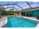 Backyard pool with seating area, perfect for enjoying sunny days and outdoor gatherings at 2122 Meadow Lark Rd, Spring Hill, FL 34608