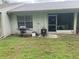 Back patio with a grill and screened-in porch, perfect for outdoor relaxation and entertaining at 2850 Westmoreland Ct, New Port Richey, FL 34655