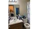 Functional bathroom with a single vanity, toilet, and shower/tub combination, decorated with a butterfly-themed curtain at 2850 Westmoreland Ct, New Port Richey, FL 34655