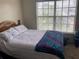 Well-lit bedroom with a cozy bed and a large window, offering a relaxing and inviting space at 2850 Westmoreland Ct, New Port Richey, FL 34655