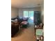 Comfortable living room featuring a large sectional couch and sliding doors to the patio at 2850 Westmoreland Ct, New Port Richey, FL 34655