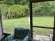 View from the screened porch of a lush backyard with privacy at 2850 Westmoreland Ct, New Port Richey, FL 34655
