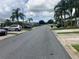 Neighborhood street featuring sidewalks and mature palm trees at 2850 Westmoreland Ct, New Port Richey, FL 34655