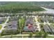 Aerial view displays the home in a neighborhood near a lake and a wooded area at 3056 Abrams Trl, Odessa, FL 33556
