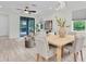 Inviting dining area open to living space with modern lighting and light wood tile floors at 3056 Abrams Trl, Odessa, FL 33556
