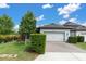 Charming home with a well-maintained lawn, a paver driveway, and a two-car garage at 3056 Abrams Trl, Odessa, FL 33556