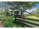 Inviting home exterior with lush landscaping, manicured hedges, and a fenced perimeter at 3056 Abrams Trl, Odessa, FL 33556