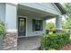 Welcoming front porch with stone accents, neat shrubbery and a covered entryway at 3056 Abrams Trl, Odessa, FL 33556