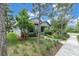 Charming home featuring a well-manicured front yard with lush landscaping and mature trees at 3056 Abrams Trl, Odessa, FL 33556