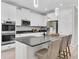 Modern kitchen with stainless steel appliances, a center island, and sleek white cabinetry at 3056 Abrams Trl, Odessa, FL 33556