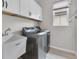 Bright laundry room featuring modern stainless steel appliances, lots of cabinet space and a window at 3056 Abrams Trl, Odessa, FL 33556
