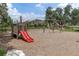 Enjoy the community playground with a fun slide, swings, and a safe, wood-chipped surface for to explore at 3056 Abrams Trl, Odessa, FL 33556