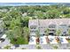 Aerial view of three-story townhome with lush landscaping and trees in a waterfront community at 3119 Oyster Bayou Way, Clearwater, FL 33759