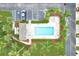Aerial view of the community pool, showcasing its size, surrounding landscaping, and parking area, appealing for leisure at 3119 Oyster Bayou Way, Clearwater, FL 33759