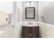 Charming powder room featuring a granite vanity, mirror, and views to an adjacent living space at 3119 Oyster Bayou Way, Clearwater, FL 33759