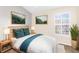 Inviting bedroom with nature-inspired artwork, soft lighting, and a serene atmosphere at 3119 Oyster Bayou Way, Clearwater, FL 33759