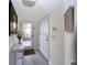 Bright entryway with white walls, light wood floors, console table, and glass paneled door at 3119 Oyster Bayou Way, Clearwater, FL 33759