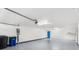 A clean garage with ample space, overhead lighting, and blue accent door at 3119 Oyster Bayou Way, Clearwater, FL 33759