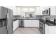 Modern kitchen with stainless steel appliances, granite countertops, and white cabinets at 3119 Oyster Bayou Way, Clearwater, FL 33759