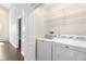Convenient laundry room with washer, dryer, and wire shelving for ample storage at 3119 Oyster Bayou Way, Clearwater, FL 33759