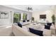 Spacious living room with large couches, ceiling fan, and sliding glass doors to balcony at 3119 Oyster Bayou Way, Clearwater, FL 33759