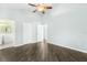 Spacious main bedroom with a ceiling fan, wood floors, and adjacent bath at 3119 Oyster Bayou Way, Clearwater, FL 33759