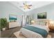 Cozy main bedroom featuring a dresser, nightstands, artwork, and access to the balcony at 3119 Oyster Bayou Way, Clearwater, FL 33759