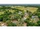 Aerial view of the property surrounded by trees, and showing the home, pool and surrounding area at 31726 Sylvian Ln, Dade City, FL 33525