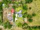 Aerial view of the property showcasing the home, landscaping, pool, driveway, and surrounding area at 31726 Sylvian Ln, Dade City, FL 33525