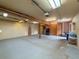 Spacious basement with concrete floors, wood beam support, bright lights, and lots of storage at 31726 Sylvian Ln, Dade City, FL 33525