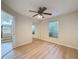Bedroom featuring a ceiling fan, mirrored closet, and wood-look floors at 31726 Sylvian Ln, Dade City, FL 33525