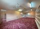 Bonus room with red carpet, window for natural light, closet, sink, and built-in shelves at 31726 Sylvian Ln, Dade City, FL 33525