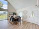 Bright dining room with vaulted ceilings, neutral walls and decorative accents, blending sophistication and comfort at 31726 Sylvian Ln, Dade City, FL 33525