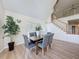 Dining area with modern table and chairs, great natural light and staircase at 31726 Sylvian Ln, Dade City, FL 33525