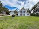 Charming house with an expansive front yard, detached garage and unique architecture at 31726 Sylvian Ln, Dade City, FL 33525