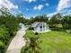 Charming home with a well-manicured lawn, garage, and bright exterior paint under a clear blue sky at 31726 Sylvian Ln, Dade City, FL 33525